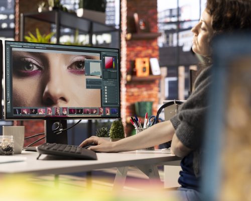 Digital media expert working on photo editing with a professional software at the creative agency, software tools. Using dual monitors to finish retouching with innovation in graphic design.