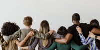 Rearview of diverse people hugging each other